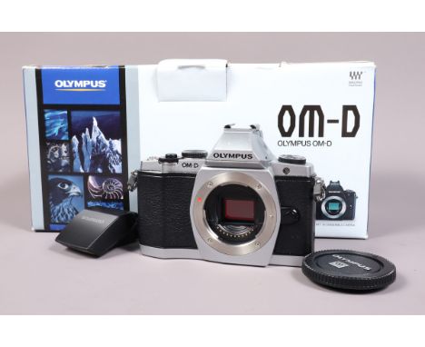 An Olympus OM D E-M5 Digital Camera Body, powers up, shutter working, otherwise untested, body G-VG, with flash unit, body ca
