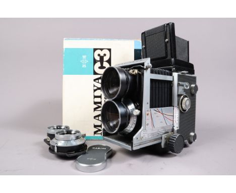 A Mamiya C3 Professional TLR Camera, body G, moderate wear to base, dirt specks to mirror, pairs of Mamiya-Sekor 105mm &amp; 