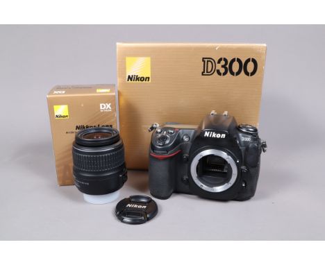 A Nikon D300 Camera, powers up, shutter working, body G, in maker's box, with battert/charger, strap &amp; manual, with a  AF