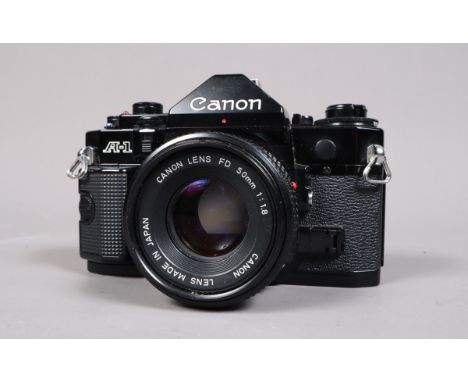 A Canon A-1 SLR Camera, black, serial no 743403, shutter working, meter responsive, body G-VG, with 50mm f/1.8 FD lens, barre
