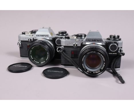 Two Olympus OM 10 SLR Cameras, both shutters working, meters responsive, self timers working, both with manual adapters, bodi