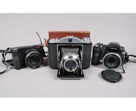 A Crystar 15 Folding Roll Film Camera and Two Digital Bridge Cameras, a Crystar 15, made in Japan circa 1954, dual format 6 x