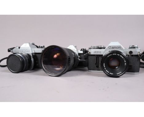 A Canon AE-1 and Two Pentax SLR Cameras, a Canon AE-1 SLR, shutter working, meter reacts to light, battery check/self-timer l