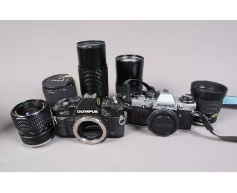 Two Olympus Cameras, an Olympus OM40 body, shutter working, meter responsive, body F, some brassing and wear, an OM10, mirror