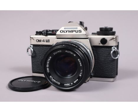 An Olympus OM 4 Ti SLR Camera,  serial no 1121137, shutter working, meter responsive, self timer working but missing front be