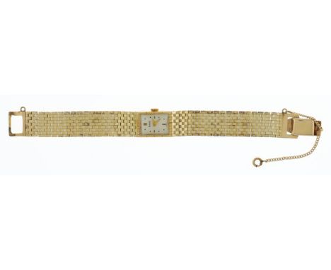 Piaget 14K Woman's Wrist Watch. Rectangle, polished metal face, with abstract numeral indicators. Stamped "14 K" on back and 