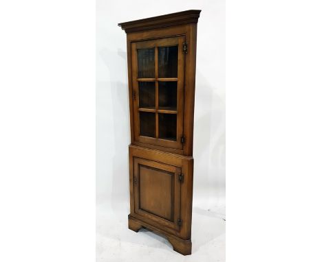 20th century oak corner display cabinet with glazed door enclosing three shelves, above cupboard door, to bracket feet 