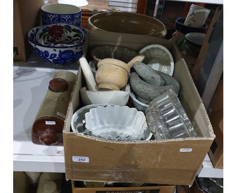 Box of various glass and ceramic jelly moulds and a wooden pestle and mortar