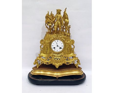 19th century eight-day mantel clock, the enamel circular dial with Roman numerals and in elaborate gilt metal case with scrol