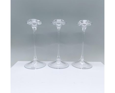 An elegant pair of clear candlesticks featuring a rounded base, a slender stem, and a cymbal-shaped top with a candle holder.