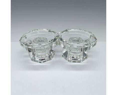 These versatile candle holders consist of two pieces each, allowing for various configurations. Made from exquisite clear cry
