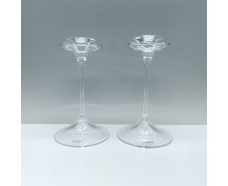 An elegant pair of clear candlesticks featuring a rounded base, a slender stem, and a cymbal-shaped top with a candle holder.