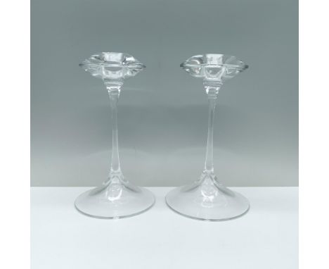 An elegant pair of clear candlesticks featuring a rounded base, a slender stem, and a cymbal-shaped top with a candle holder.