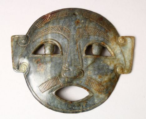 A GOOD CARVED JADE MASK, 14.5cm wide, 12.5cm high.