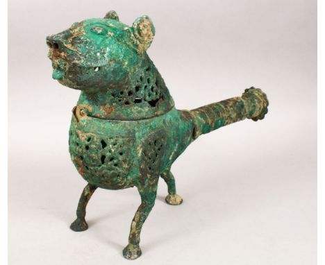 A LARGE METALWORK KHORASHAN STYLE BRONZE INCENSE BURNER IN THE FORM OF A LION, with openwork decoration and handle, supported