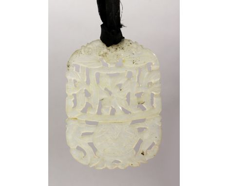 A GOOD 19TH / 20TH CENTURY CHINESE CARVED CLEAR JADE PENDANT, carved to depict floral display, 7cm x 5cm