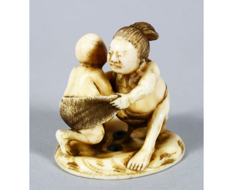 A GOOD JAPANESE MEIJI PERIOD CARVED IVORY NETSUKE OF TWO WRESTLERS, the two wrestlers captured mid fight, the base with an in