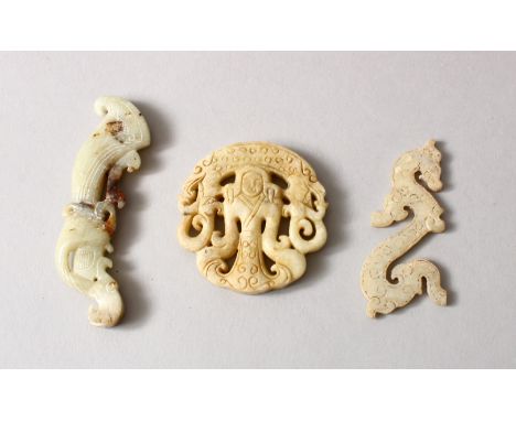 THREE CHINESE CARVED JADE / HARD STONE PENDANTS, two depicting figures, one in the form of a chilong, 8cm, 6cm , 5.5cm. (3)