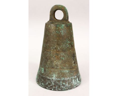 AN EARLY ISLAMIC BRONZE TEMPLE BELL/GONG, the lower section with carved calligraphy, 24cm high, 15cm diameter.