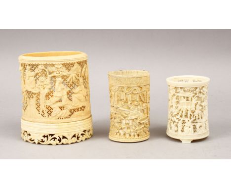 THREE 19TH CENTURY CHINESE CARVED IVORY TUSK VASE SECTION, the larger with carved and pierced decoration depicting figures in