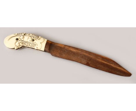 AN UNUSUAL 19TH CENTURY SRI LANKAN IVORY HILTED DAGGER / PAGE TURNER, with a wooden blade, the ivory carved, 29cm long.