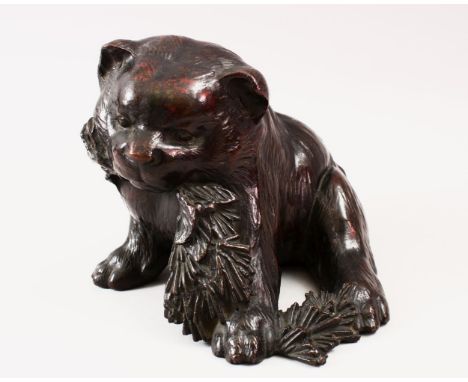 A FINE QUALITY JAPANESE MEIJI PERIOD BRONZE AKITA PUPPY OKIMONO, the pup moddled in a seated position whilst chewing a branch