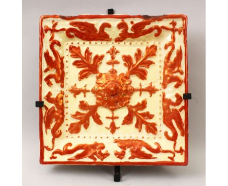 A 19TH CENTURY SPANISH LUSTREWARE TILE, decorated with moulded floral and mythical beast design, 29.5cm square.