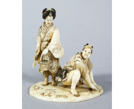 A GOOD JAPANESE MEIJI PERIOD CARVED IVORY OKIMONO - SHELL COLLECTORS, the male and female figure hunting for shells, the lady