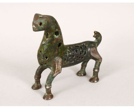A 12TH/13TH CENTURY ISLAMIC SELJUK BRONZE LION, with openwork decoration, 11cm long, 10.5cm high.
