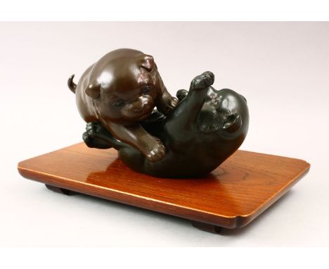A GOOD JAPANESE MEIJI PERIOD BRONZE AKITA PUPPY OKIMONO GROUP, one puppy moddeled upon its back in a playful pose whilst the 