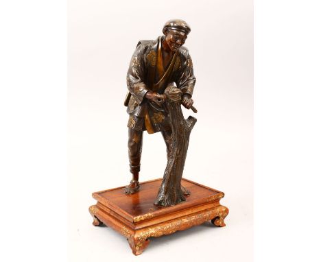 A GOOD JAPANESE MEIJI PERIOD PARCEL GILT BRONZE OKIMONO OF A WOODMAN , attributed to "Miyao Eisuke", the man working on a tre
