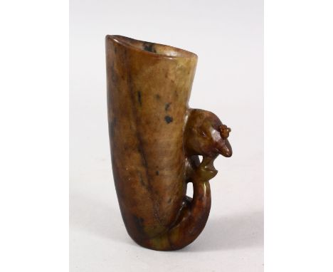 A GOOD CHINESE CARVED JADE / HARDSTONE LIBATION CUP, carved with a mythical bird head moulded handle, 13cm high x 8 cm wide.