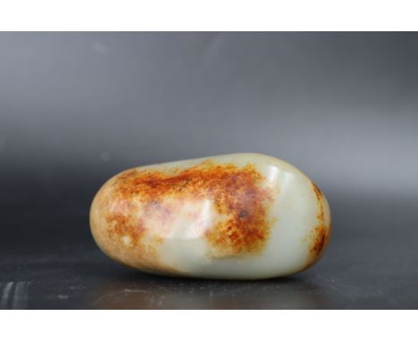 A Jade Pebble Snuff Bottle, 18th/19th century L:6.3cm, W:3.3cm Good condition, area of minor natural rivering on flat side 