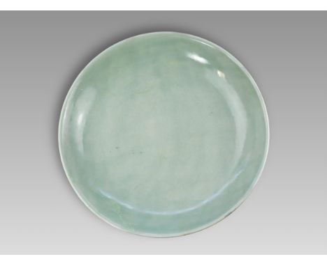 within a double circle, and of the period,finely incised overall with an elegant flowering lotus scroll, across the centre an