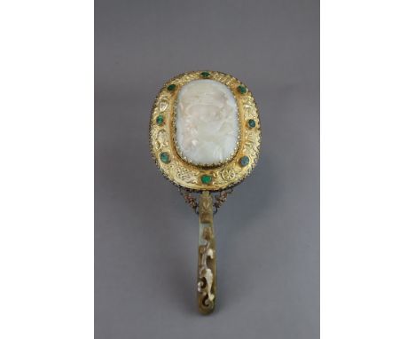 the chased oval gilt frame set with a celadon jade landscape plaque, and mounted with a celadon and brown jade belthook, L:28