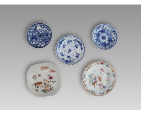 a pair of circular saucers depicted female figures in underglaze blue and white, the other blue and white floral shape saucer