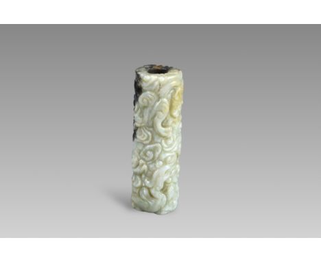 A Black and Celadon Jade Cylinder carved with  Chilong, Ming dynasty, densely carved over the exterior in low relief with a p