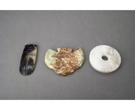 the bi disc carved from a pale celadon stone, with grain pattern on each side; together with a black jade cicada ,probably la