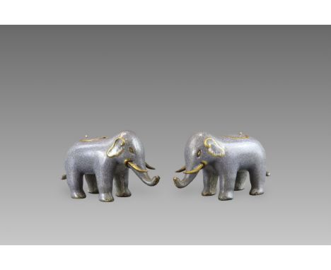 the charming beasts standing foursquare with trunks slightly raised, enamelled overall in a speckled grey colour imitating el