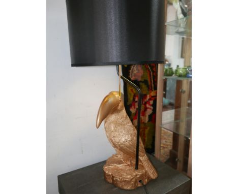 A contemporary table lamp, with a gilt a gilt composite toucan base and black drum shade, H.71cm 