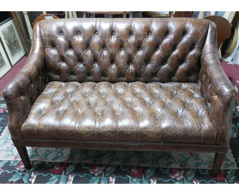 A 'Halo' two seater sofa with brown leather and stud bound button back upholstery, raised on tapered legs, H.86 W.135 D.48cm 