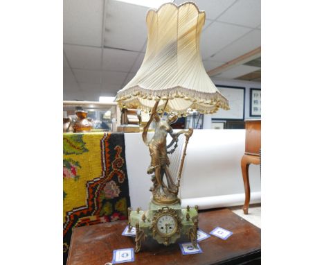 A late 19th century French style gilt spelter and onyx mantel clock with lamp held aloft (some damage to base), H.120cm inclu