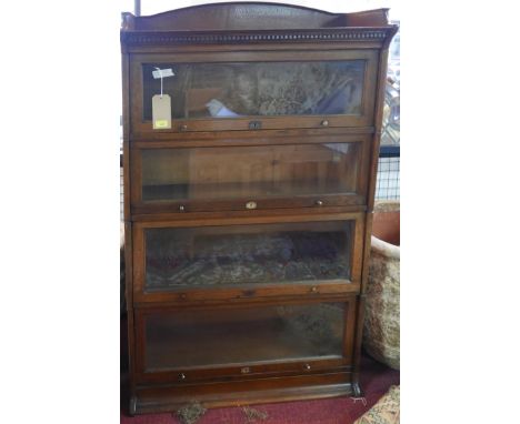 A Lebus oak four section stacking bookcase, bears plaques, H.142 W.88 D.36cm 