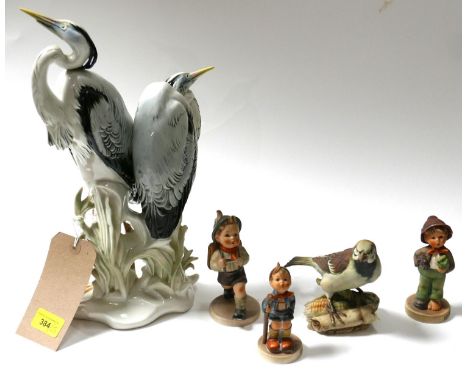 A Continental porcelain study of two herons, on a naturalistic base, indistinctly marked to base, H.34cm, together with three