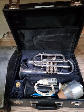 A B&M CHAMPION BRASS TRUMPET With two mouthpieces, in hard carry