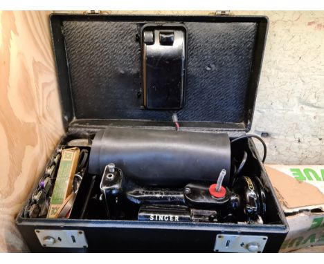 A circa 1950s - 1960s Singer Featherweight Convertible electric portable sewing machine, model 222K, with accessories, instru