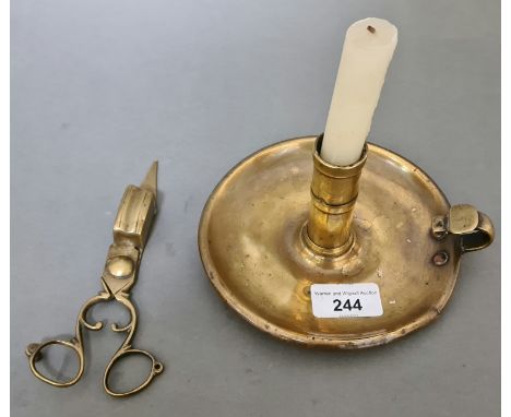 An early 19th century brass candlestick and snuffer. 