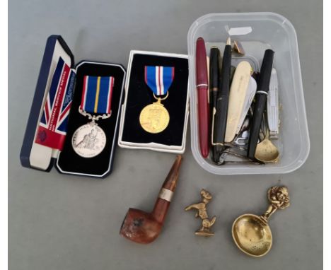 A mixed lot including medals, penknives, pens, pipe etc. 