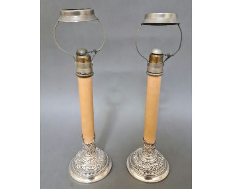 Pair of late Victorian silver candle stands with embossed decoration London 1897, William Comyns, each fitted with a Greens p