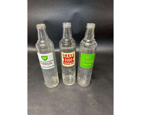 Three glass quart motor oil bottles: BP Energol (x2) and Shell X-100.